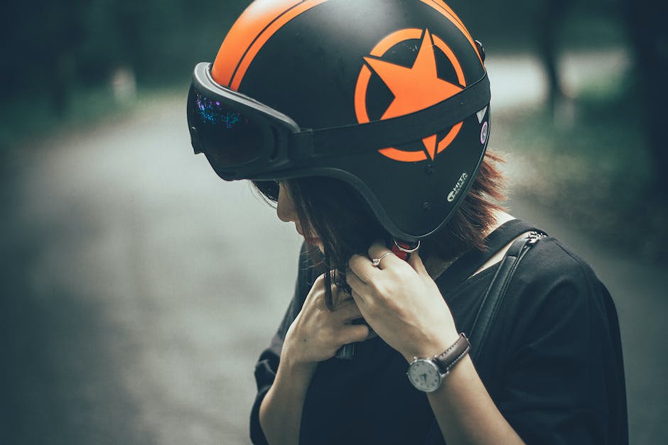 Image of a person wearing a helmet while riding an e-bike, emphasizing the importance of helmet usage for safety.